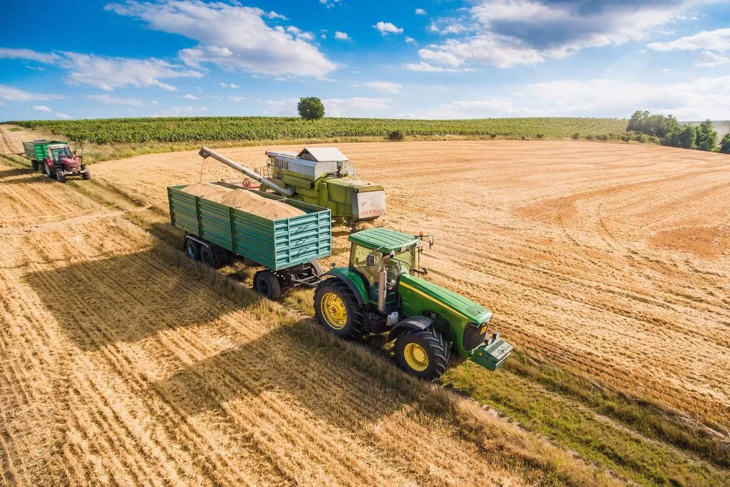 combine harvester pouring grain into trailer towed by tractor free stock photos picjumbo DJI 0118 2210x1473